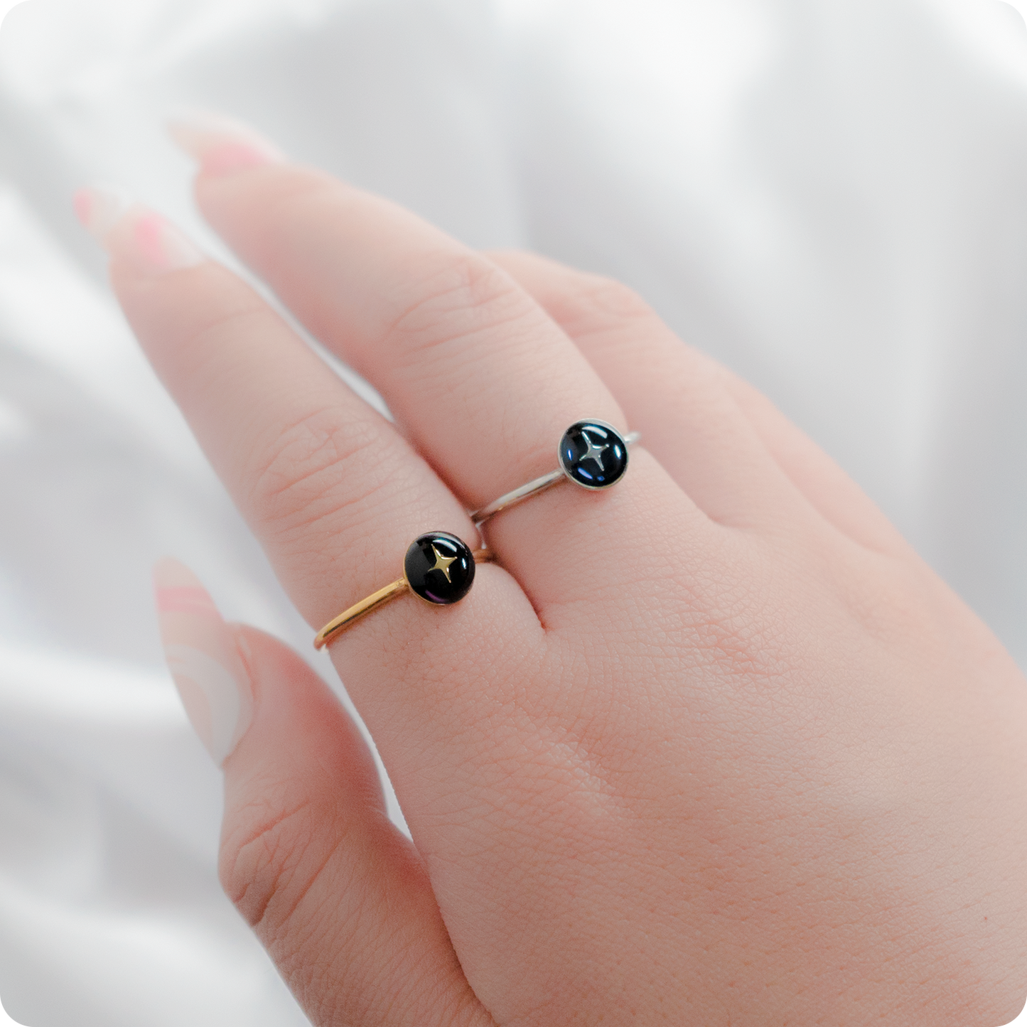 Celeste Faerie Gold and Silver Estrella Ring close-up on fingers