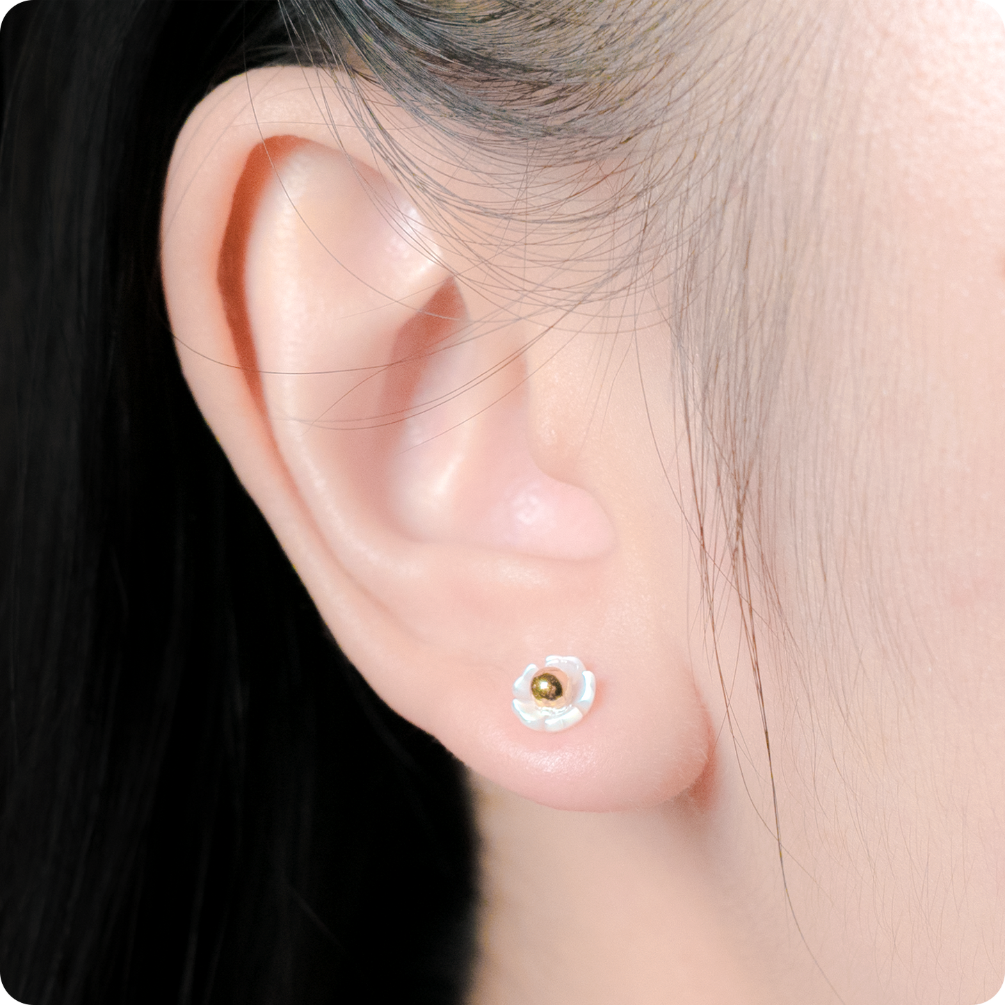 Celeste Faerie Faerie studs close-up on woman's ear